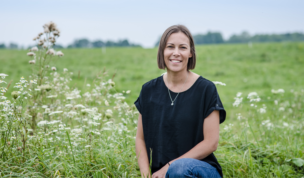 Casey Whitehouse smiles in a field on PEI