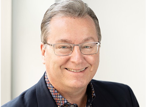 Photo of person wearing glasses and smiling