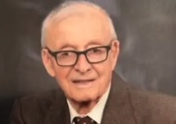 Michael "Mike" Hennessey was the first Registrar at UPEI. Portrait photo of a man wearing glasses