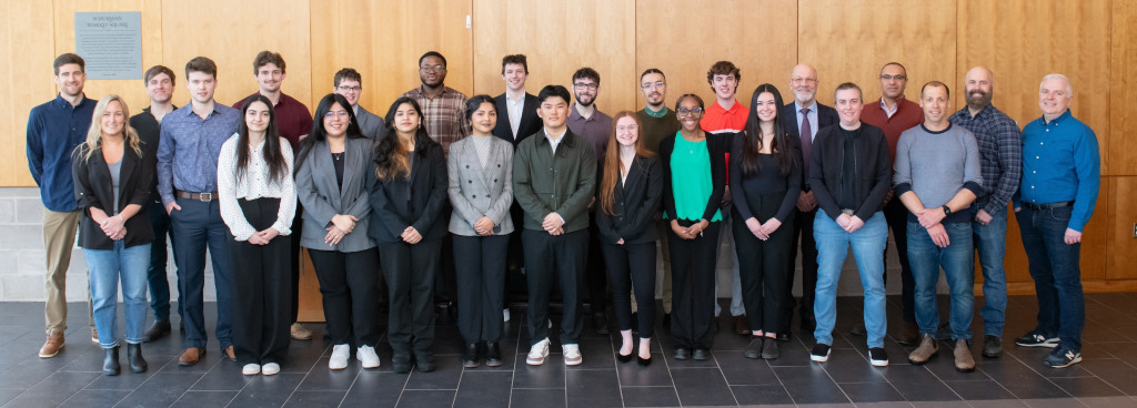 Four BUS-3910 student teams with representatives from UPEI Facilities Management, the Transportation and Parking Advisory Committee, and officials from the City of Charlottetown and the provincial government. Four BUS-3910 student teams with representatives from UPEI Facilities Management, the Transportation and Parking Advisory Committee, and officials from the City of Charlottetown and the provincial government.
