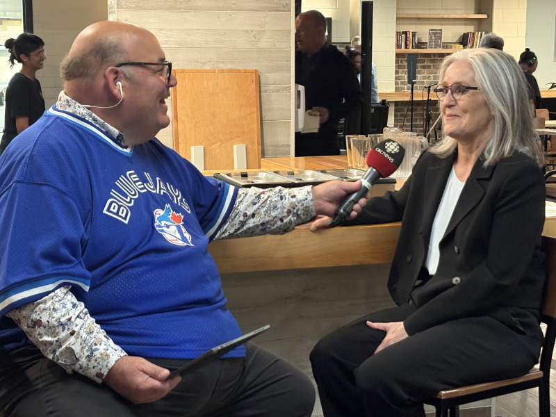CBC PEI's Mitch Cormier interviews President Wendy Rodgers during the live radio broadcast of Island Morning that took place on campus on October 9 Man holding a microphone while interviewing a woman