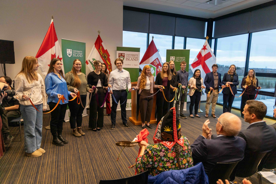 photo of a group of students holding pieces of ribbon