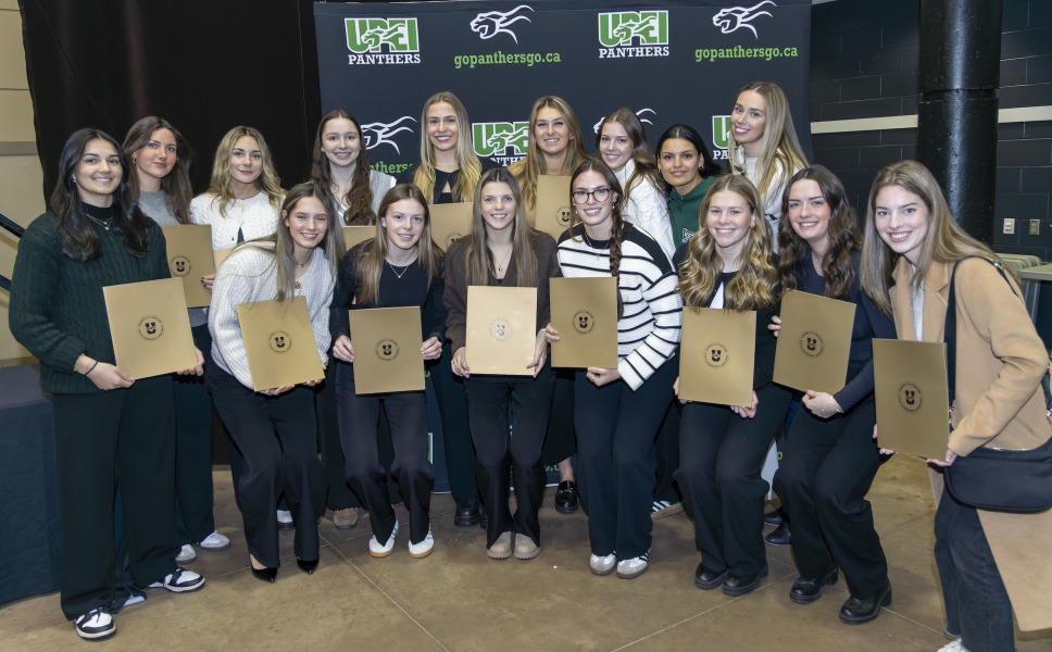 Members of the UPEI Women’s Hockey team gather for a photo after they receive their U SPORTS Academic All-Canadian certificates.