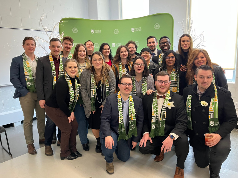 Large group of people standing in front of a photo backdrop