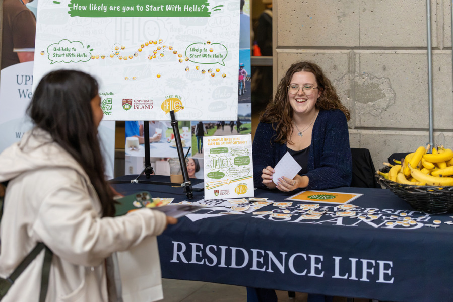 A UPEI student chats with Jordynne Mann, Residence Life Coordinator, at the “Start with Hello” table during Welcome Week 2026.