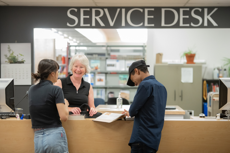 Students get help at the library service desk