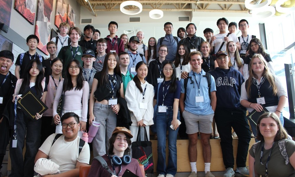 a large group of high school students in the Sustainable Design Engineering lobby