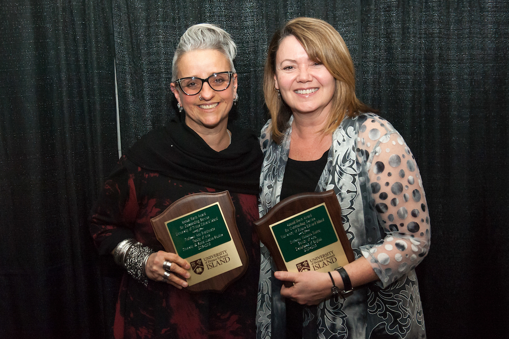 dr. ann braithwaite and dr. shannon murray pose with award plaques