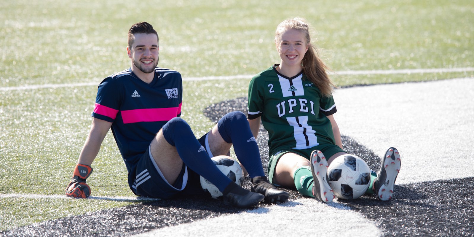 two UPEI soccer panthers smiling on the pitch