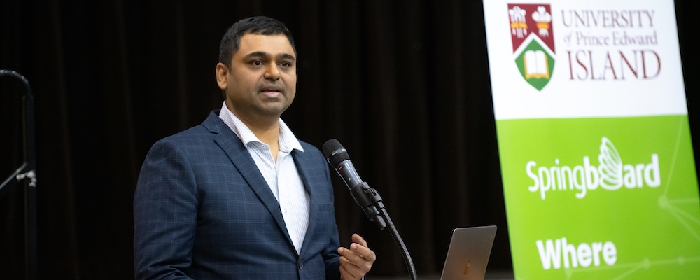 Dr. Senthilkumar Thiruppathi speaking at a microphone