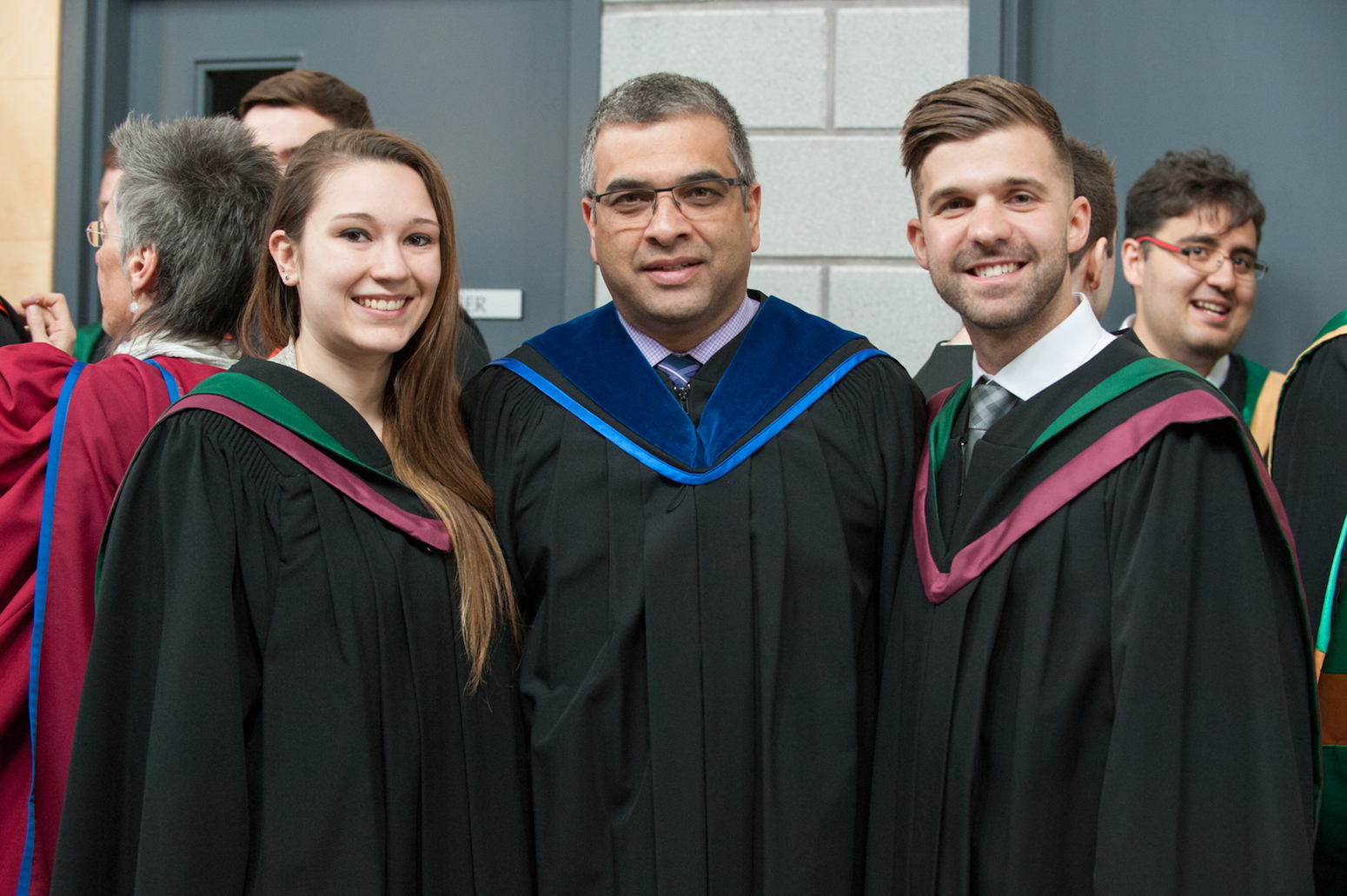 BSc in Paramedicine graduates Damia Scott, left, and Mike Hannah, right, are pictured with Dr. Trevor Jain, program director.