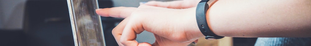 two hands pointing at a computer screen