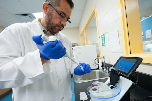 veterinarian adding liquid to a scientific container