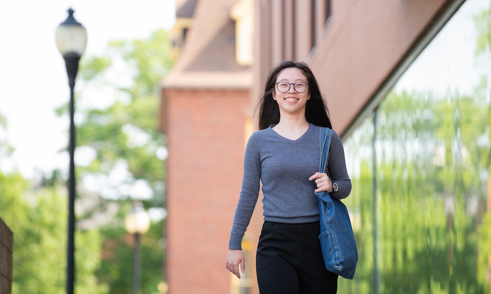 UPEI student EeVon Lim walking outside a building