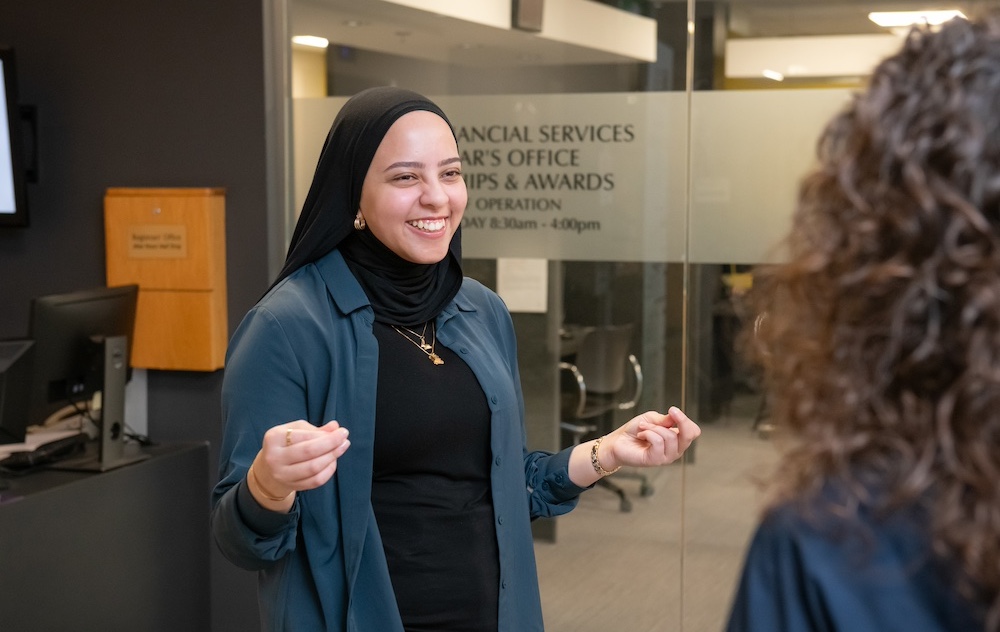 UPEI staff member Fairouz talking with a co-worker