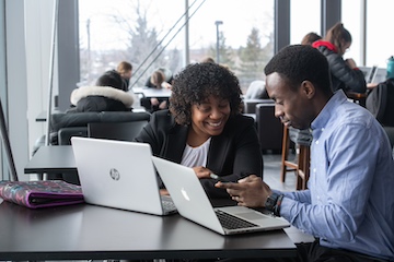two students working at a laptop computer