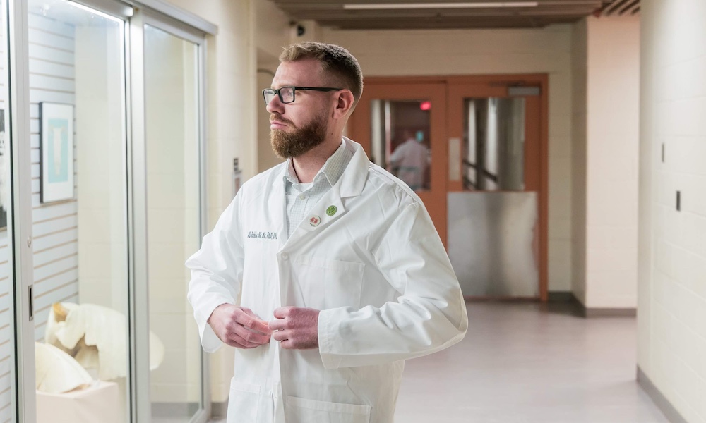 Dr. Will Robbins in a white lab coat