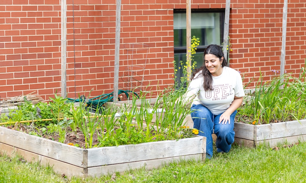 UPEI BEd student Priya Jain by Chaplaincy Centre garden