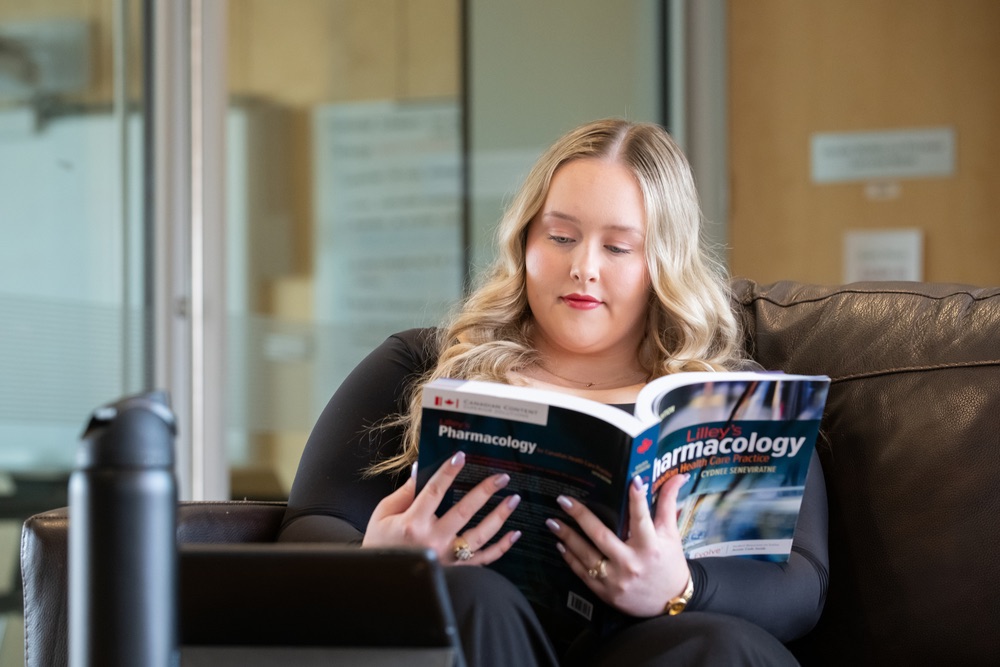 UPEI nursing student Kayla MacLeod reading a pharmacology textbook