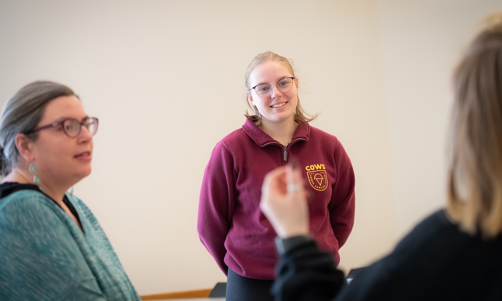 UPEI education student Madi speaking to two lecture participants