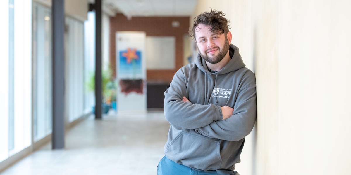 upei nursing graduate mitchell bingley in the health sciences building hallway