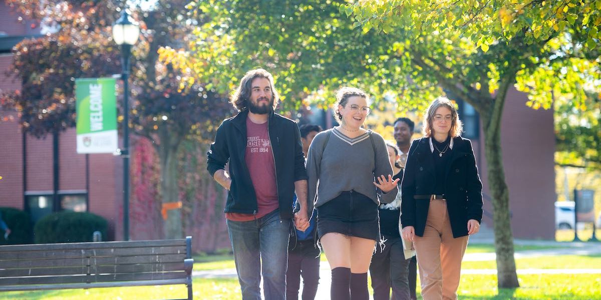 a group of students walking in UPEI's quad in fall