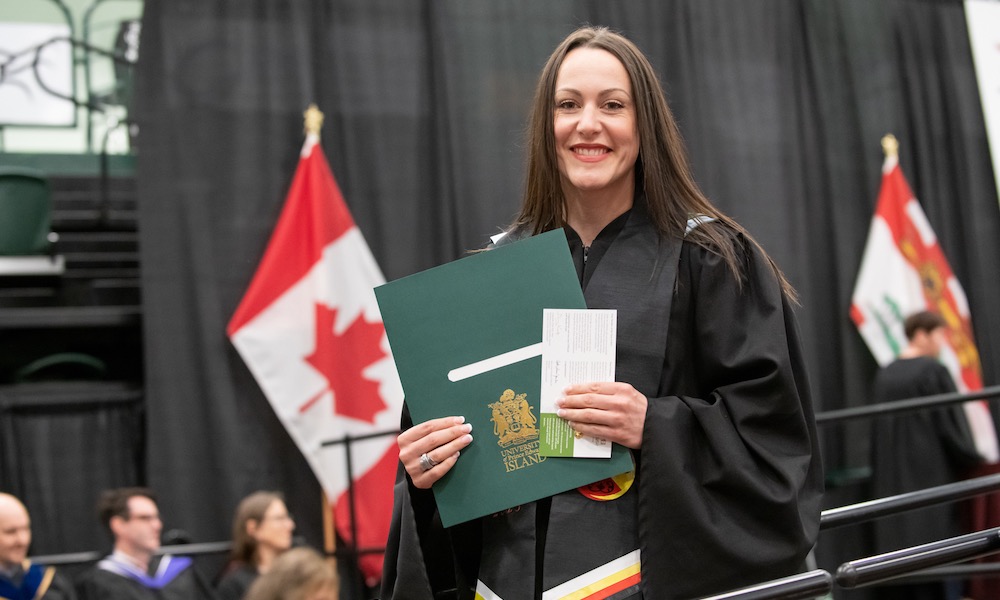 Nicole at UPEI Convocation holding her degree