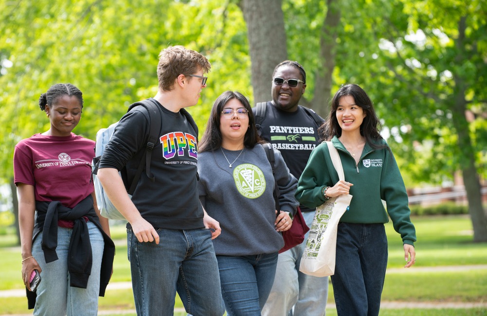 a group of five students wearing UPEI-branded clothing