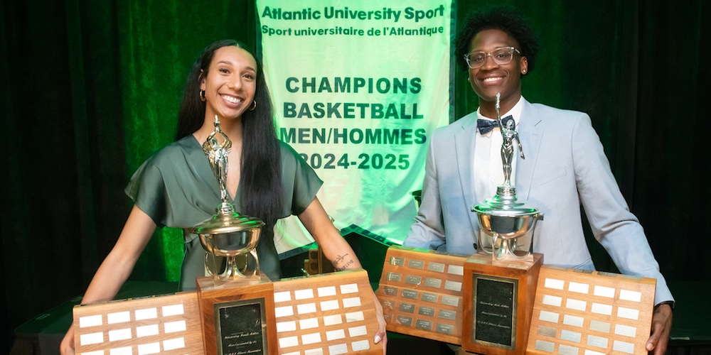two Panther student athletes receiving Athlete of the Year trophies