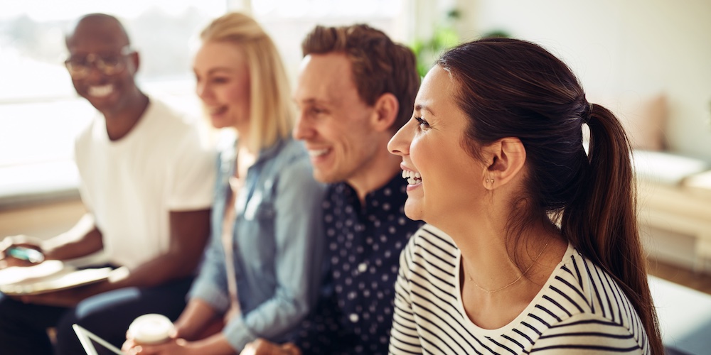 four smiling people