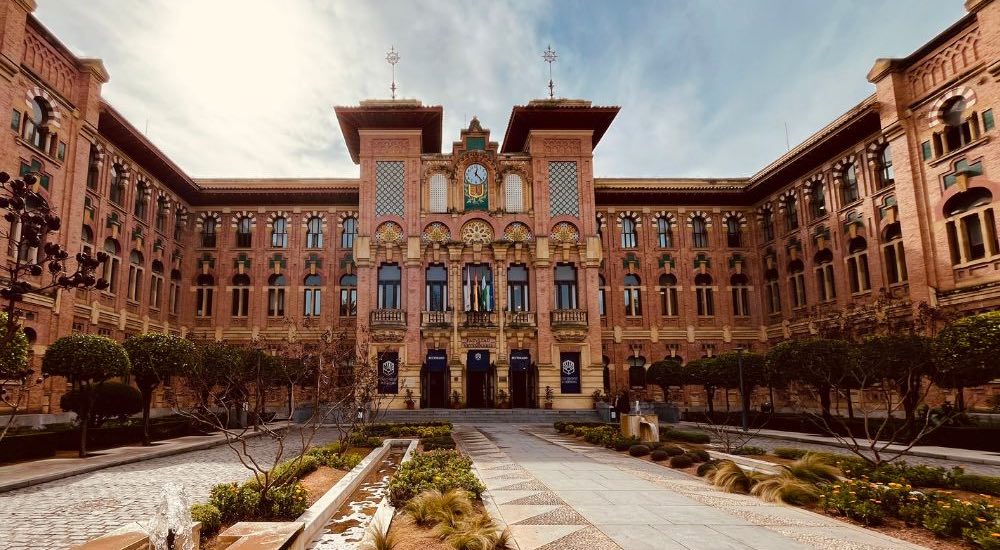 front of a stone building at the University of Cordoba, Spain