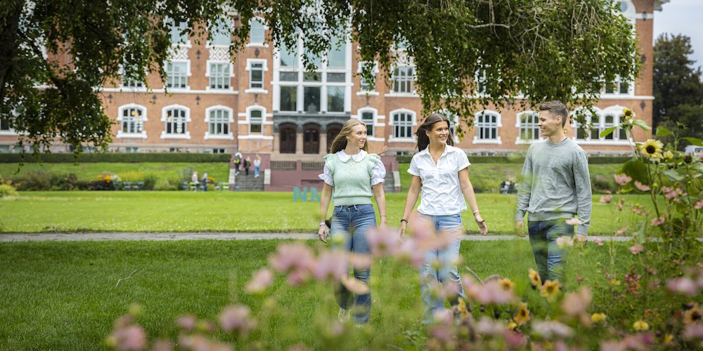 three students walking the grounds of a Norwegian university
