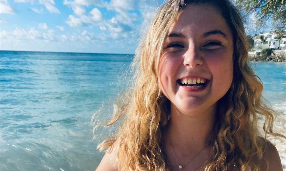 a female student with the ocean behind