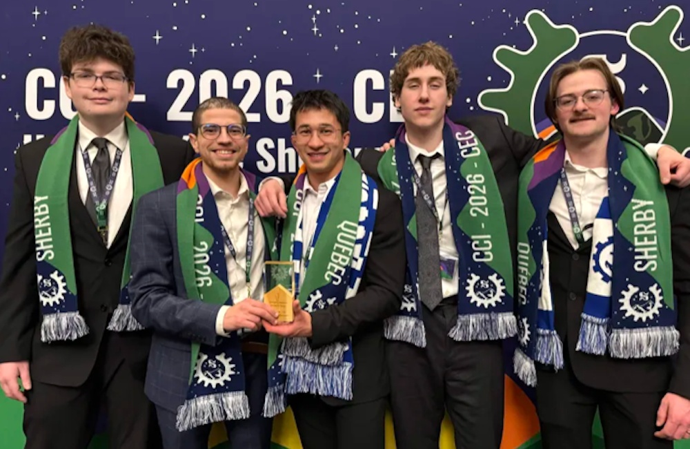 five engineering students posing with an award