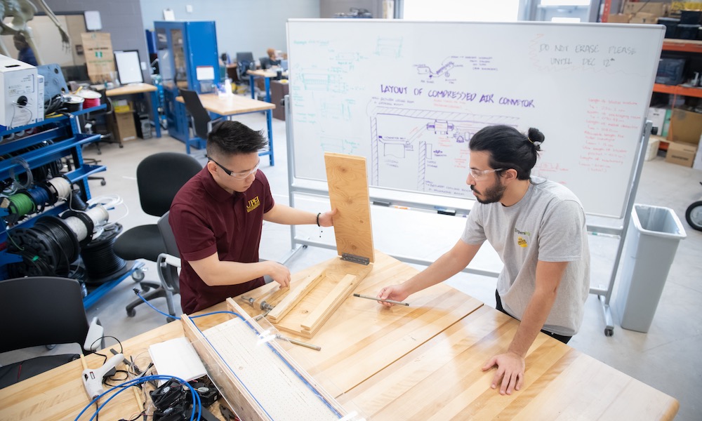 UPEI engineering student Yvan working with another student in the Faculty of Sustainable Design Engineering building lab