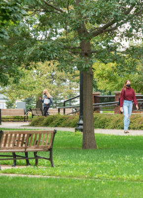 image of student wearing mask in the quadrangle