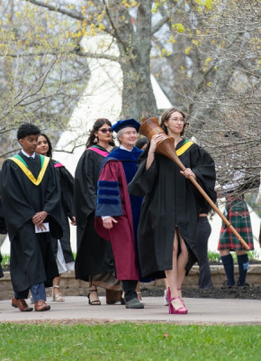 Marshal, Sue Dawson; Macebearer, Shanelle Berthier, Faculty of Science; and Eagle Feather Bearer, Erin Reid, assistant professor, Faculty of Indigenous Knowledge, Education, Research, and Applied Studies, lead graduates in the Faculty of Science into the Chi-Wan Young Sports Centre for their Convocation ceremony on May 16. 