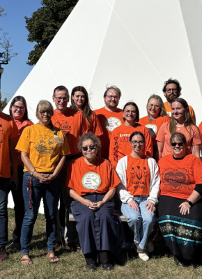 photo of people in front of a tipi
