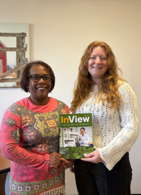 Two women holding magazine