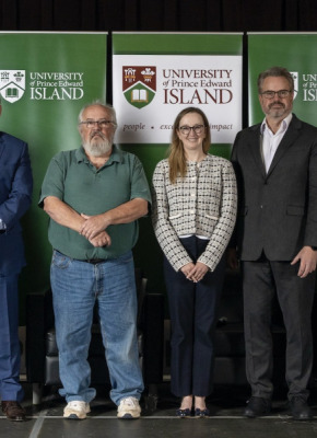 photo of group of people standing side by side on a stage