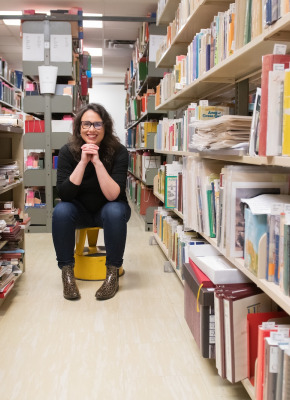 dr. kate scarth sitting between the stacks in upei's robertson library