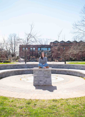 UPEI student Annika Masters in the stone theatre outside the Chaplaincy Centre