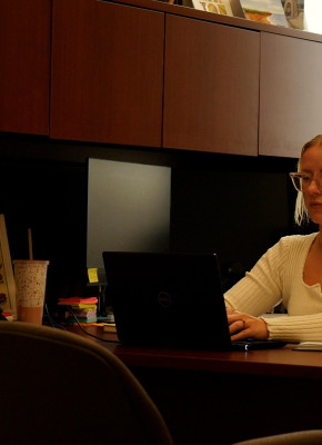 UPEI assistant professor Ashton Dougan in her office on a computer