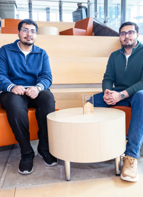 UPEI engineering students Syed Imran Ali and Syed Daniyal Ali sitting in a lit building atrium