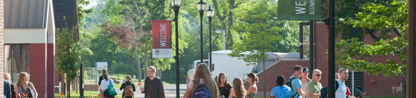 students in the quad in front of steel building