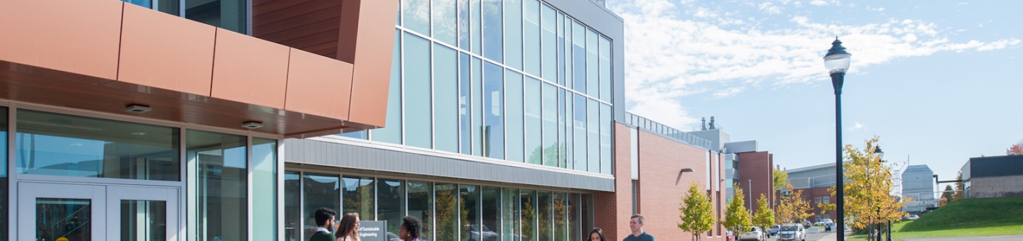 student in front of the faculty of sustainable design engineering building