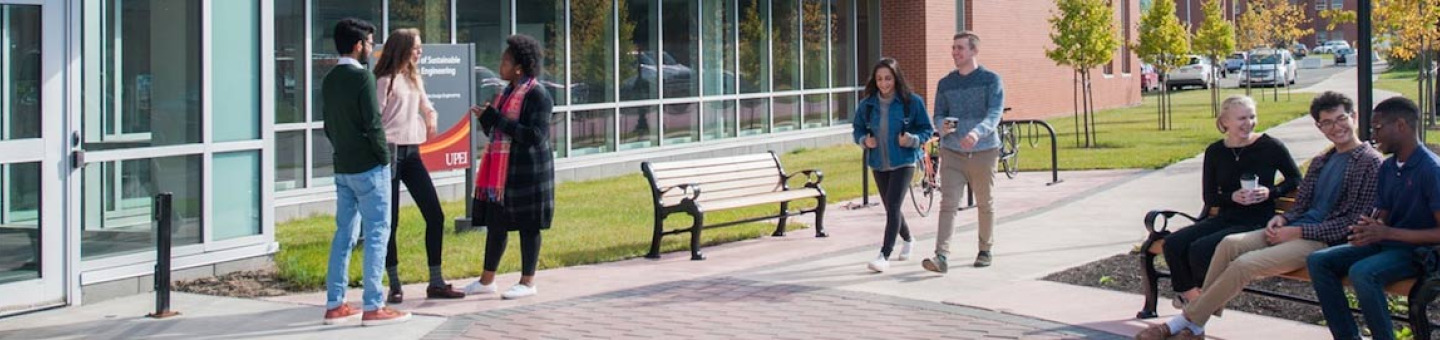 student in front of the faculty of sustainable design engineering building