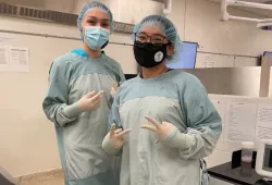 Aliyah Aglukkaq (right) poses with her friend and fellow camper Anikan Ikuallaq-Pouliot in a gowning, gloving, and suturing session during AVC Vet Camp. 