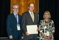 Dr. Étienne Côté (middle) during the Canadian Academy of Health Sciences induction ceremony. 
