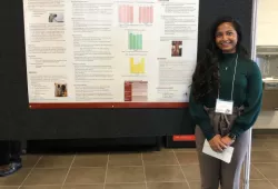 Anam Hamza poses in front of her winning poster. 